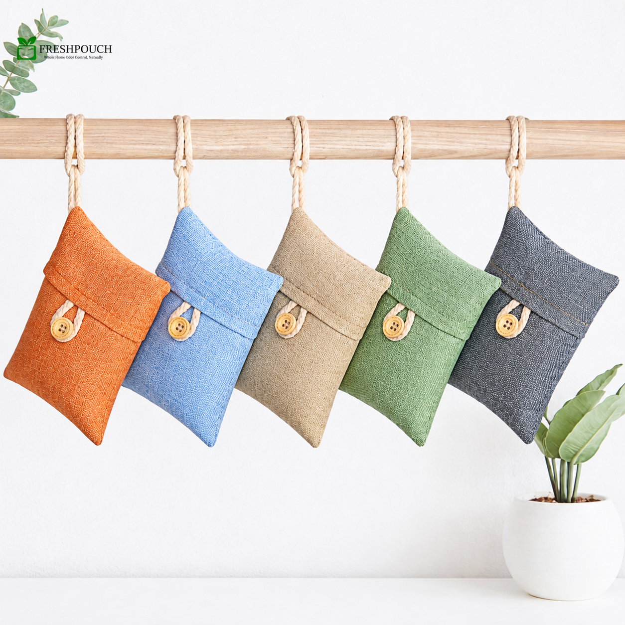 Five colorful fabric pouches hanging on a wooden rod with a white background.