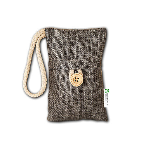 A small woven fabric pouch in a brown and beige textured material, featuring a cream-colored braided loop handle and a decorative wooden button closure on the front. A small white tag with a green leaf logo is visible on the right side.