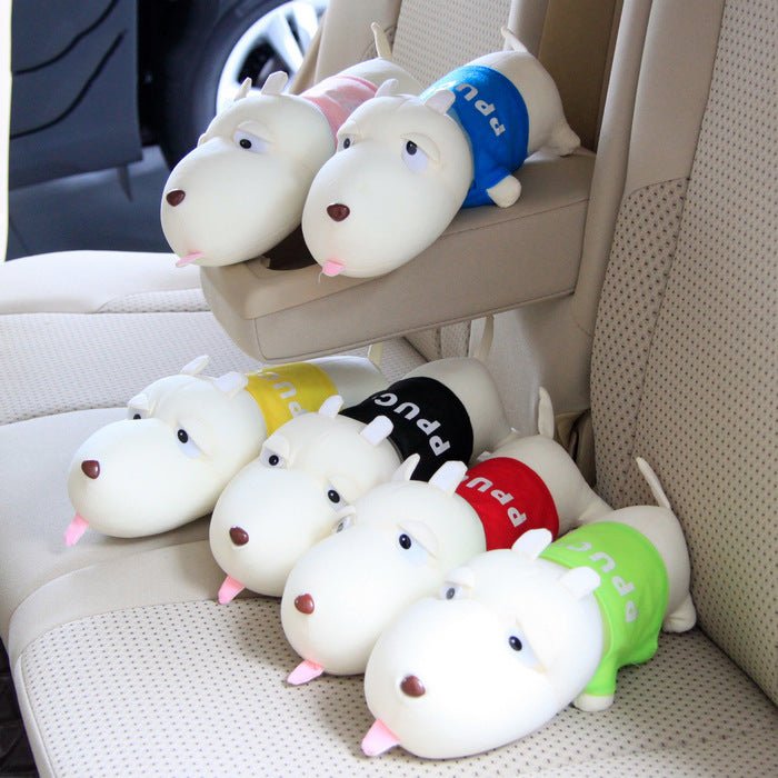 Plush dog toys with colorful collars on a car seat