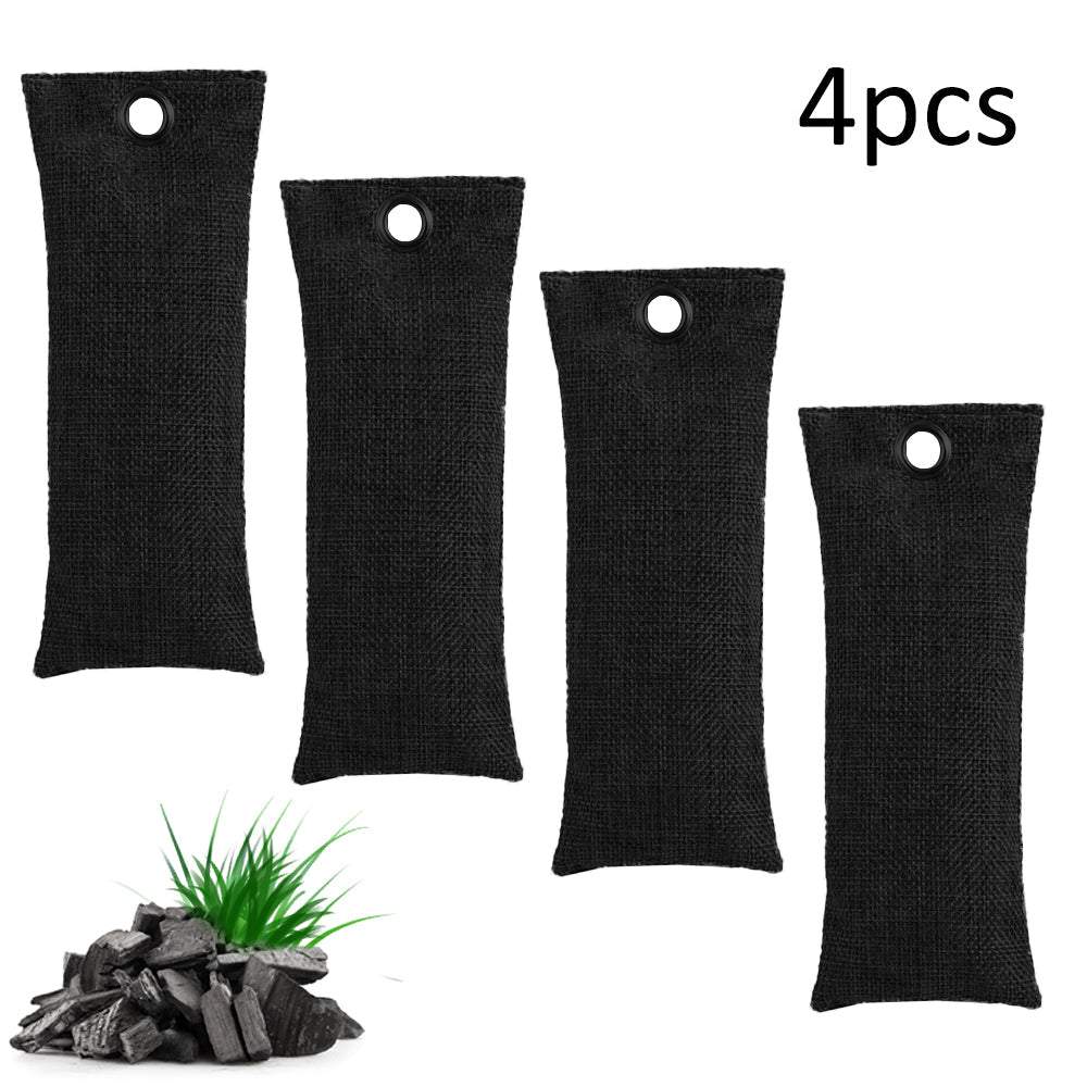 Four black fabric bags with a small plant and charcoal on a white background