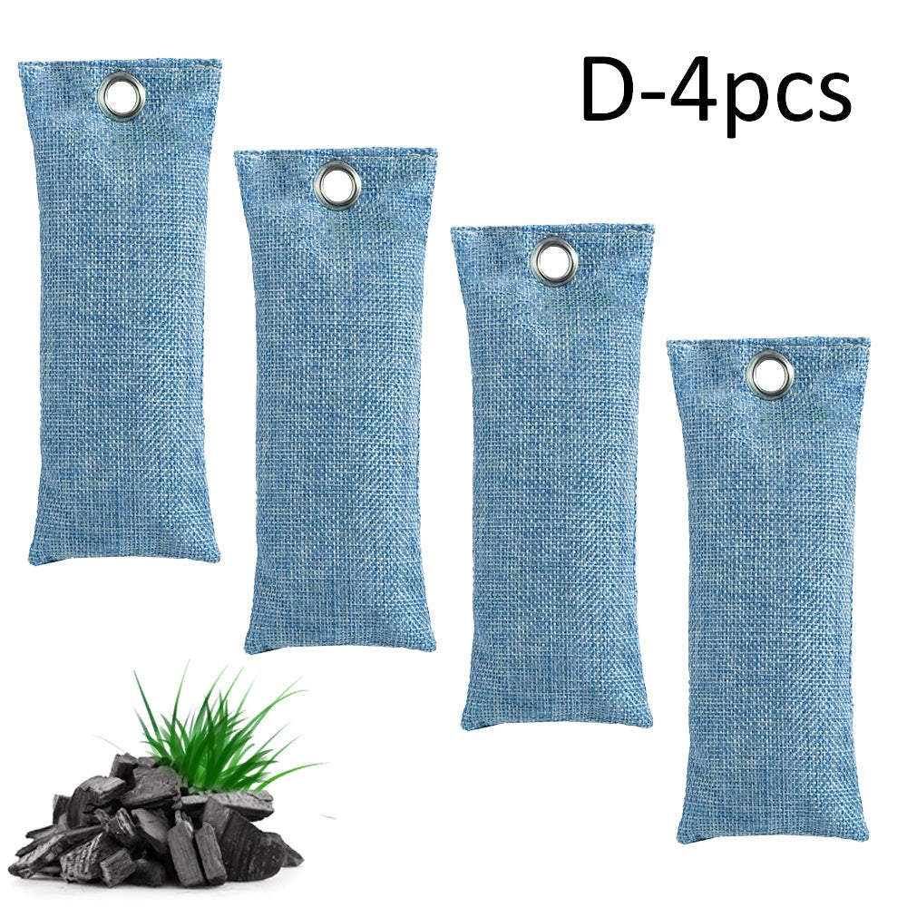 Four blue deodorant bags with a small plant and charcoal on a white background