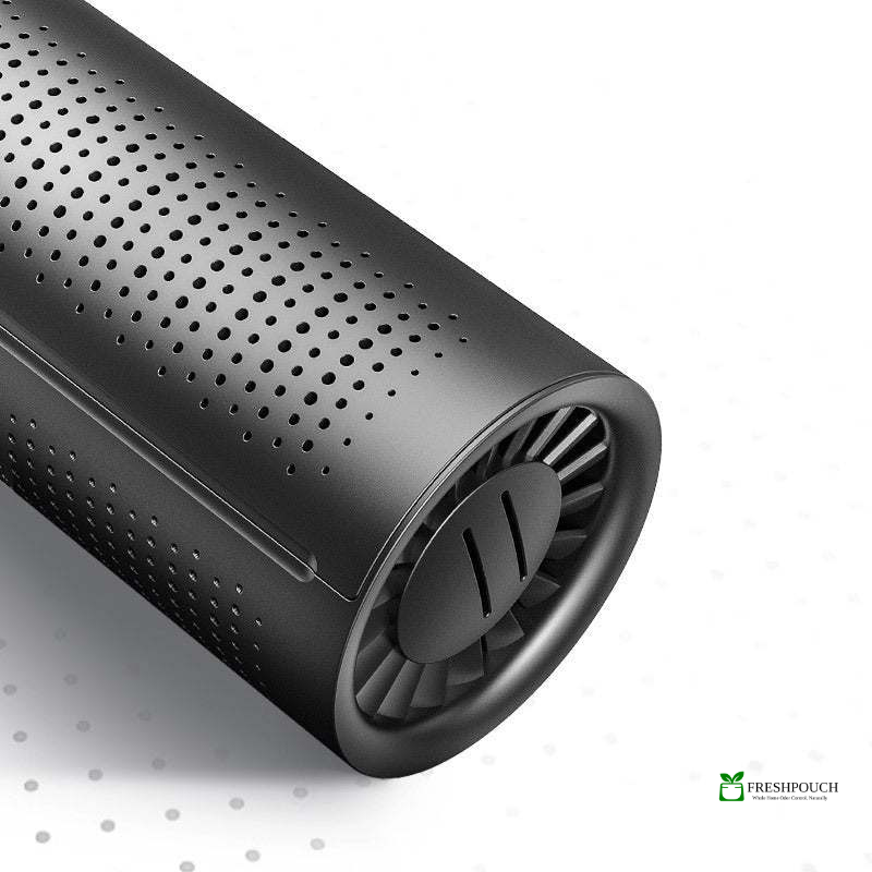 Black cylindrical device with perforated design on a light gray background